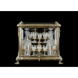 A LATE 19TH CENTURY GILT BRONZE AND GLASS DECANTER BOX WITH CUT GLASS DECANTERS AND GLASSES,