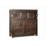 A CHARLES I CARVED OAK PRESS CUPBOARD CIRCA 1630-1640 the lunette carved frieze on cup and cover