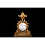 A 19TH CENTURY FRENCH GILT BRONZE MANTEL CLOCK IN THE LOUIS XVI STYLE the plinth case surmounted