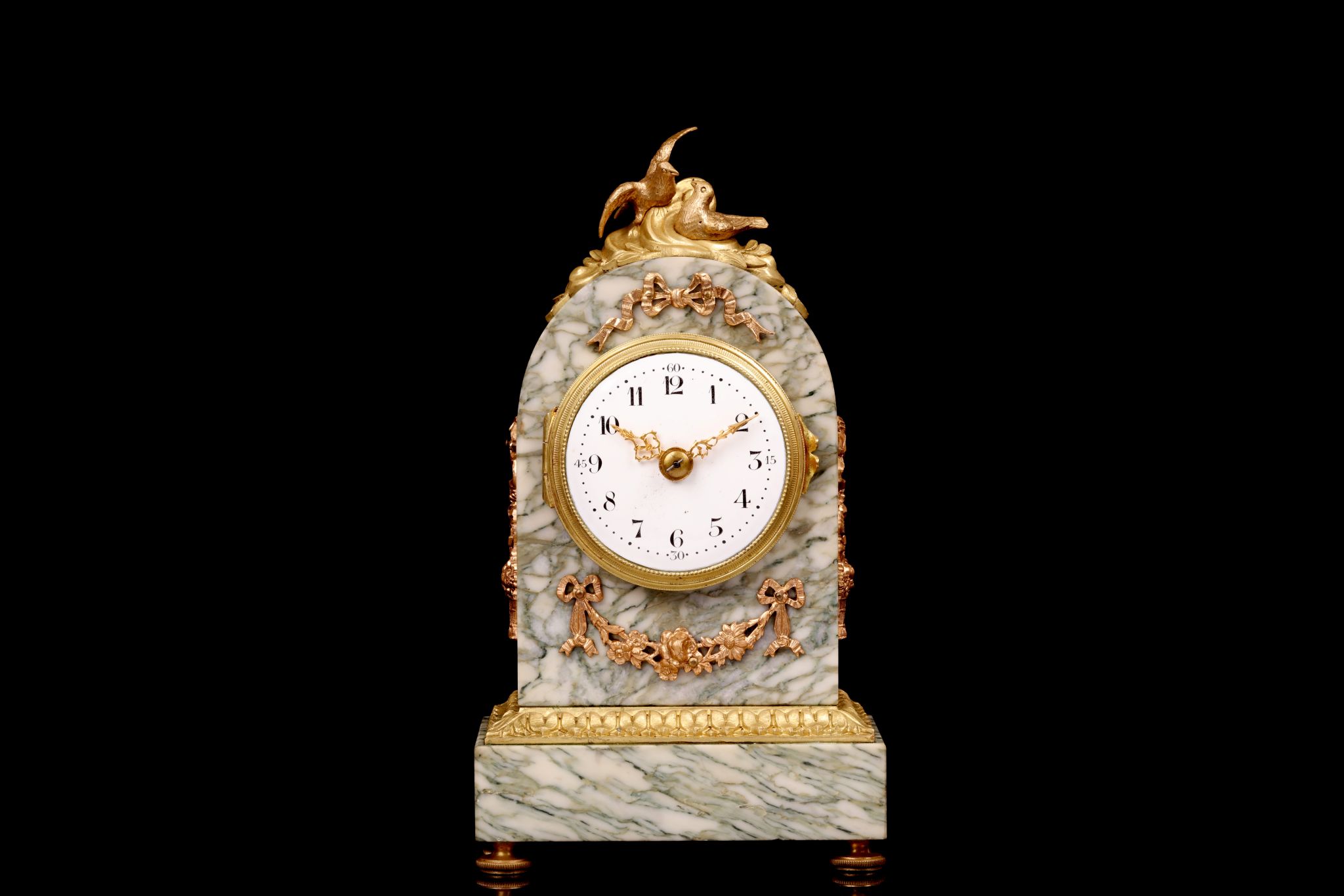 A LATE 19TH CENTURY FRENCH MARBLE AND GILT BRONZE MOUNTED BOUDOIR CLOCK the arched case surmounted