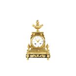 A SMALL LATE 19TH CENTURY FRENCH GILT METAL CLOCK  the case surmounted by a flambe urn and raised on