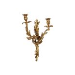 A PAIR OF ROCOCO STYLE GILT BRONZE TWIN BRANCH WALL LIGHTS modelled with scrolling foliage