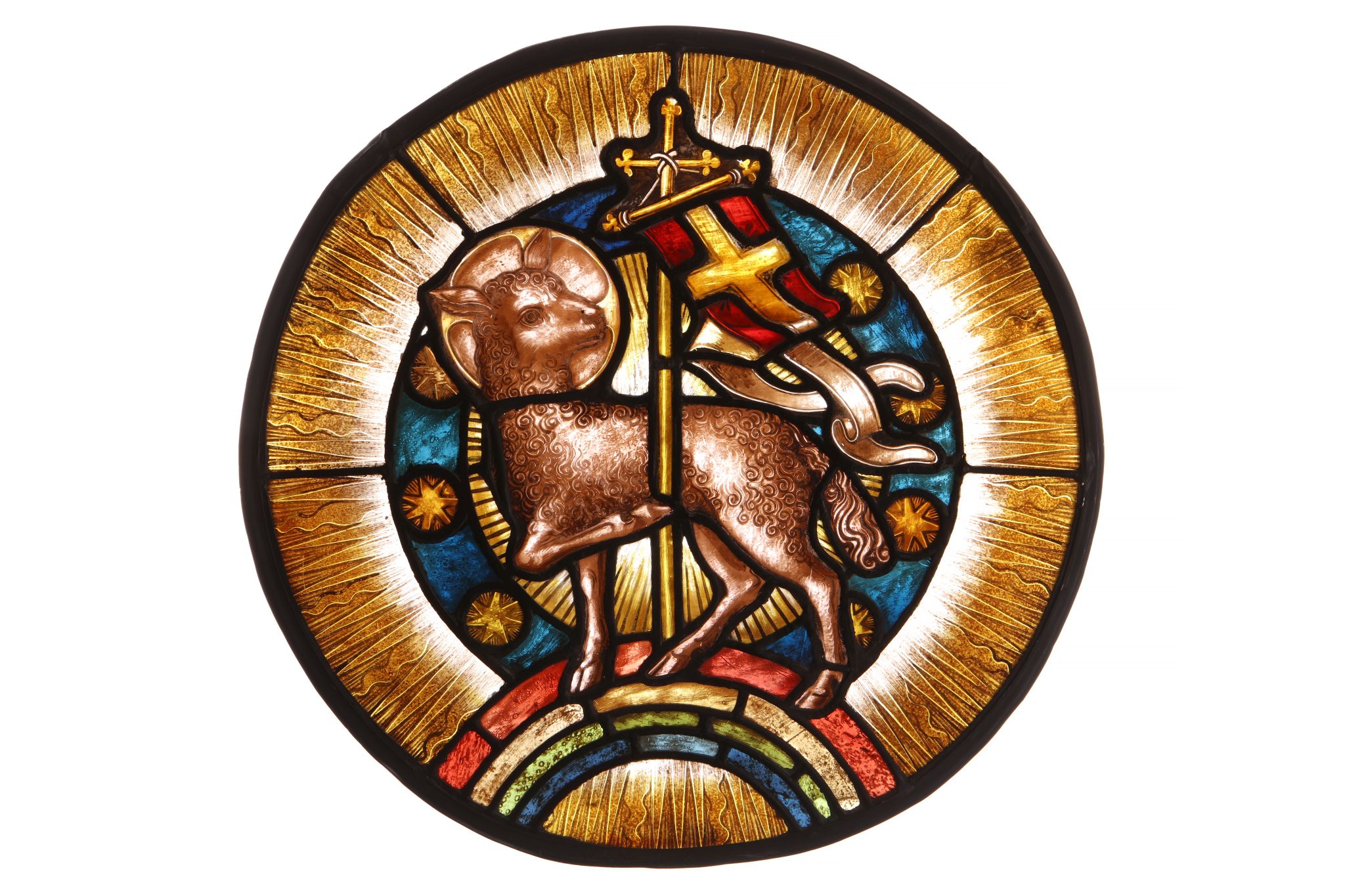A STAINED GLASS PANEL DEPICTING THE LAMB OF GOD the lamb depicted with flag and raised on a four