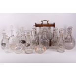 A large collection of 19th Century and later decanters, some with labels, including a tantalus,