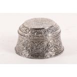 A Chinese early 20th Century silver circular shape box and cover, embossed with scrolling foliage