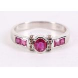 A ruby and diamond ring, The oval-cut ruby, flanked by lines of brilliant-cut diamonds, between