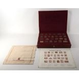 A 20th Century, red leather boxed collection of 25 Empire Collection 925 silver replica colonial