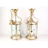 A pair of gilt and glass cylindrical hall lanterns, having 3 candle lights each.