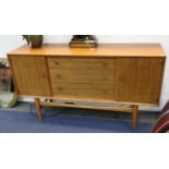 A 1950's Gordon Russell dining set, consisting of an extending dining and six chairs and sideboard