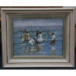 An oil painting beach scene, children paddling in shallow water, 29 x 39cm.