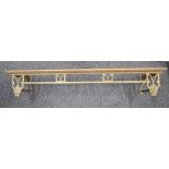 An early 20th century brass fender, with chevron shaped supports and two floral roundels, 132cm long