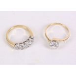 Two gold and cubic zirconia rings, One 14 carat yellow gold ring set with a single round stone, ring