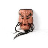 An antique Japanese carved wood and painted No mask, with bead and whiskers.