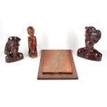 Three 20th Century Javanese carvings, to include a pair of heads and a kneeling figure, also