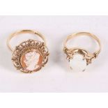 Two dress rings, One set with a shell cameo, the other with an oval opal, one with UK hallmark for 9