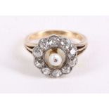 A diamond and seed pearl cluster ring, Centrally set with a seed pearl, within a surround of