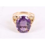 An amethyst dress ring, The oval-cut amethyst, weighing 8.25 carats, between floral shoulders,