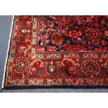 A North West Persian blue ground carpet, with floral field within a wide triple border, 320 x