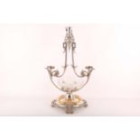 A late 19th Century Sheffield silver plated table centrepiece, raised on scrolling feet with