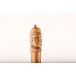 A WORLD WAR I CARVED TRENCH WALKING STICK, with Kaiser's head finial, 99cm.