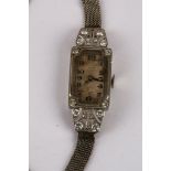 A 1920's diamond and platinum ladies cocktail watch, rectangular dial marked Arabic numerals on a
