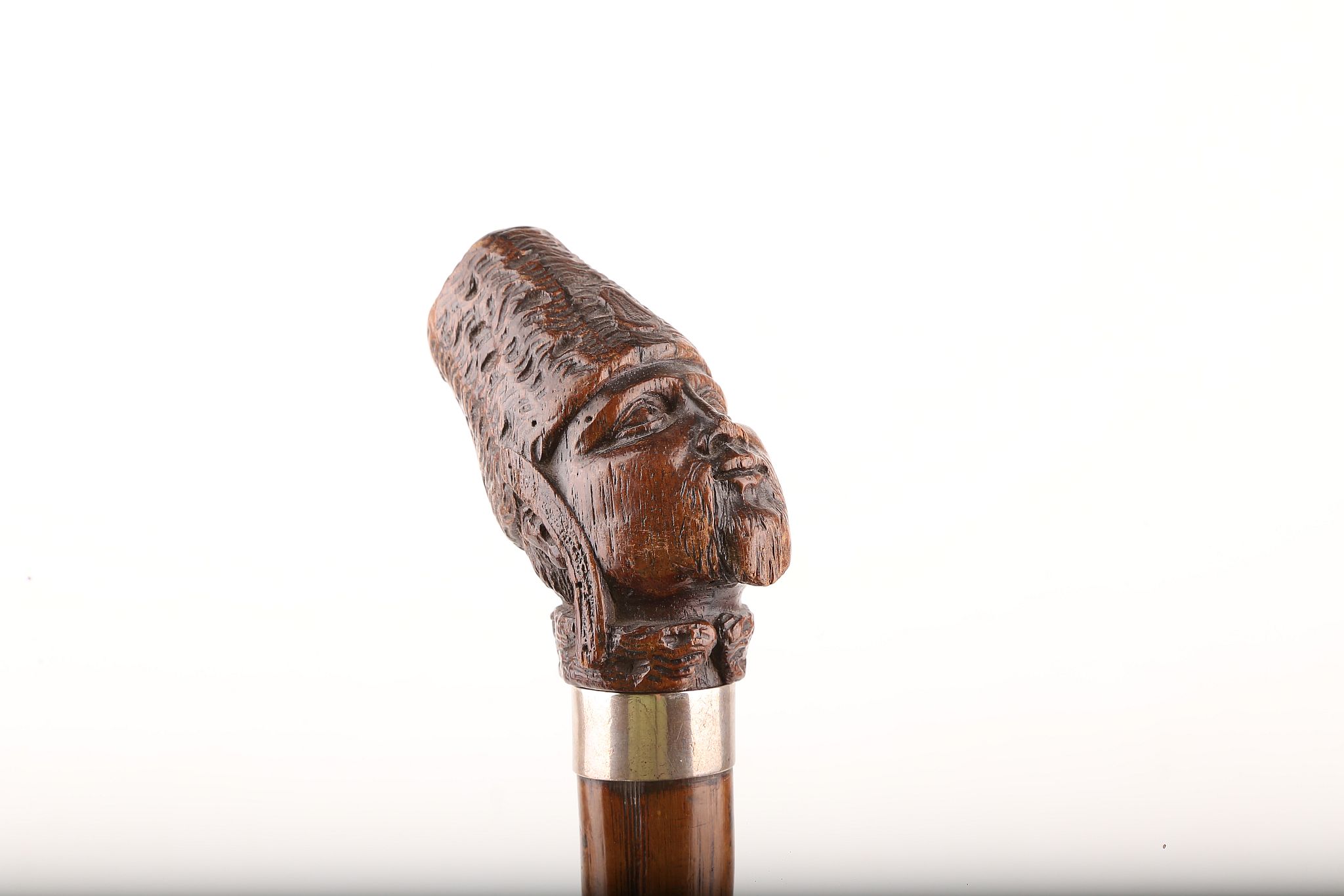 A CARVED WOOD HEAD HANDLED CANE OF A COSSAK, knotted early wood shaft, 93cm.