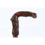 A GOOD EARLY 19TH CENTURY FOLK ART CANE, with profuse carved of people, animals and hunting