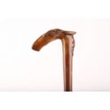 AN ANTIQUE FOLK ART WALKING CANE FROM CORFU, the grip carved with a horse's head and the words '