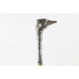 AN UNUSUAL WALKING STICK, depicting a silver plated ostrich. Mounted on a shaft made of shark