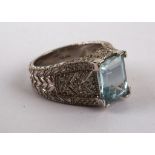 An aquamarine dress ring, the rectangular stone claw set, with diamond shoulder in 14ct white gold