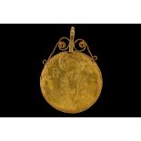 A high carat yellow metal devotional icon pendent of circular form, with rope chain border, engraved