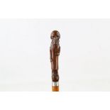 A MALACCA CANE, mounted with a full length figure of William Ewart Gladstone, 36 inches (92cm).