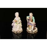 A PAIR OF MEISSEN PORCELAIN FIGURES OF CHILDREN, late 19th century, both modelled seated, he reading
