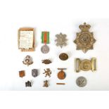 AN INTERESTING SELECTION OF TWO MEDALS, BADGES, BELT BUCKLE, CAP AND LAPEL BADGES, to include a