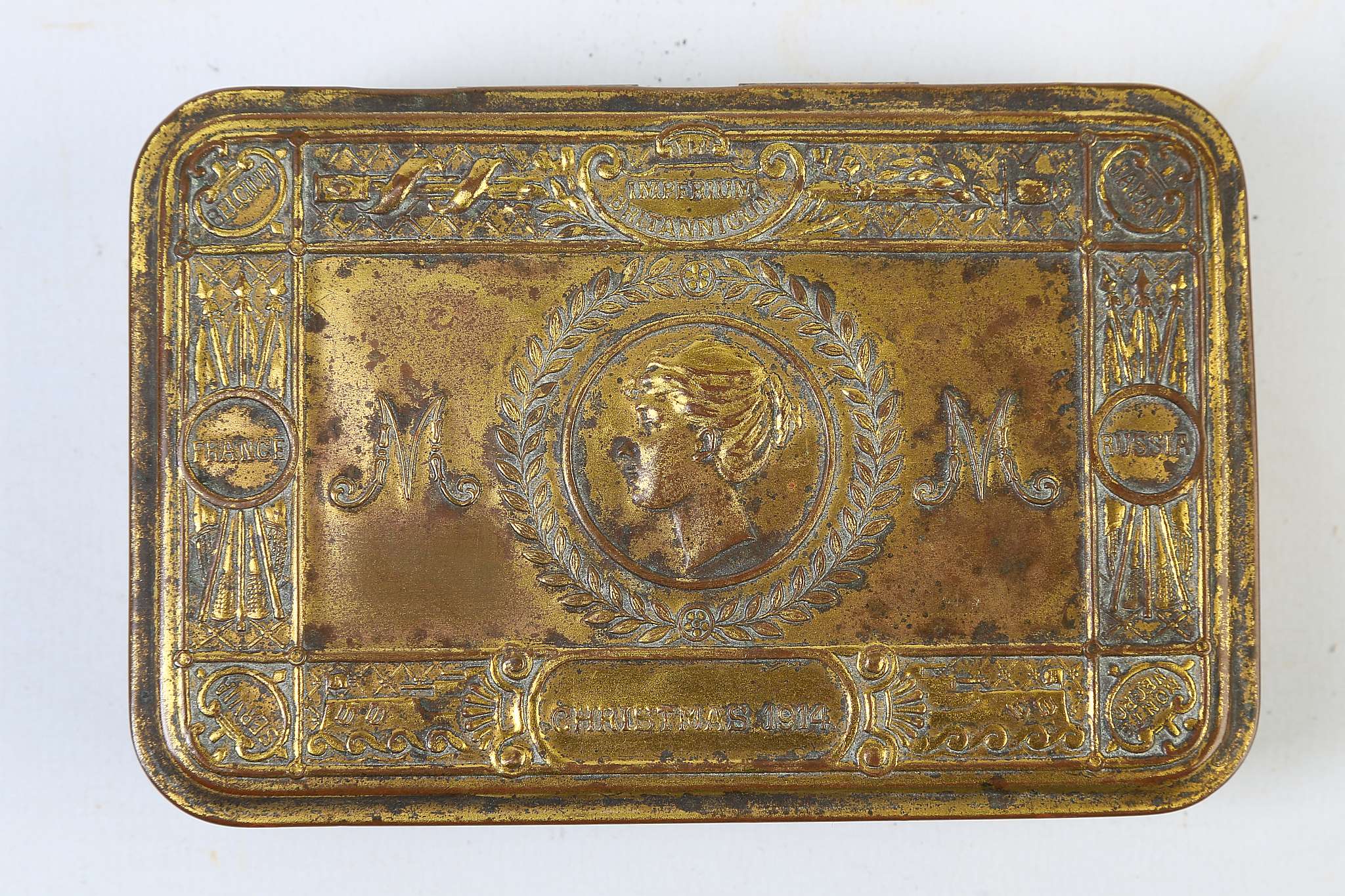 A 1914 PRINCES MARY BRASS AND GILT CHRISTMAS BOX, with embossed lid.