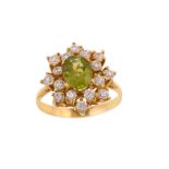 A peridot cluster ring             The oval-cut peridot, within a cluster of brilliant-cut cubic