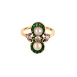 An early 20th century pearl, emerald and diamond dress ring The old brilliant-cut diamond, between