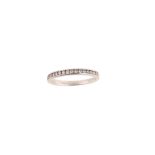 A platinum and diamond half hoop ring, by Tiffany & Co. The platinum band channel-set to the front