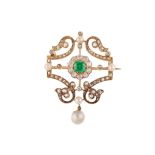 An emerald, pearl and diamond brooch, circa 1900 The openwork brooch of scrolling design, set