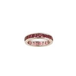 A pink tourmaline eternity ring The polished band channel-set with a continuous row of circular-