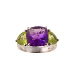 An amethyst and peridot dress ring The fancy square-cut amethyst, in a four-claw setting, between