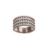 A diamond dress ring The channel-set rows of brilliant-cut diamonds, spaced by lines of similarly-