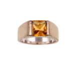 A citrine 'Torc' ring, by Cartier Centrally set with a square fancy-cut citrine, to an 18 carat