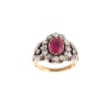 A ruby and diamond ring The oval-cut ruby, in a closed-back setting, within a surround of cushion-