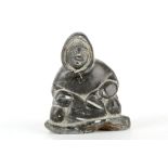 A mid 20th Century Inuit soapstone carving of an Inuit, signed to base.