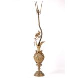 A 20th Century brass table lamp in the form of a cast ewer with putti at play, scrolls and masks,