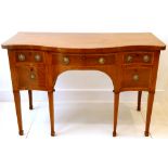 Early 20th century mahogany serpentine fronted sideboard, two pairs of short drawers flanking a long