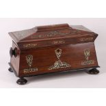 A regency rosewood sarcophagus form tea caddy with rectangular top, the interior fitted with twin