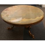 A 1960's / 1970's circular coffee table, having a brass base with central column dividing, with 3