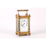 An early 20th Century French lacquered brass carriage timepiece, the rectangular white enamel dial